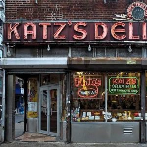 Katz’s Delicatessen is famous for its massive, hand-carved pastrami sandwiches, its enduring legacy as New York's oldest operating deli (established 1888), and its iconic feature in the 1989 film When Harry Met Sally.