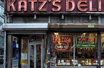 Katz’s Delicatessen is famous for its massive, hand-carved pastrami sandwiches, its enduring legacy as New York's oldest operating deli (established 1888), and its iconic feature in the 1989 film When Harry Met Sally.