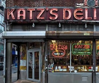 Katz’s Delicatessen is famous for its massive, hand-carved pastrami sandwiches, its enduring legacy as New York's oldest operating deli (established 1888), and its iconic feature in the 1989 film When Harry Met Sally.