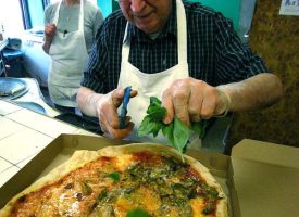 A hallmark of modern pizza started at DiFara, snipping fresh basil on the pie as soon as it comes out of the oven.