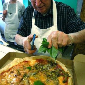 A hallmark of modern pizza started at DiFara, snipping fresh basil on the pie as soon as it comes out of the oven.