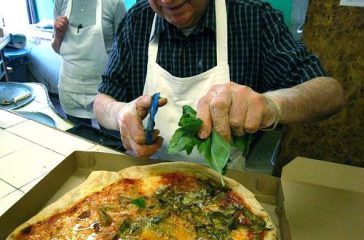 A hallmark of modern pizza started at DiFara, snipping fresh basil on the pie as soon as it comes out of the oven.
