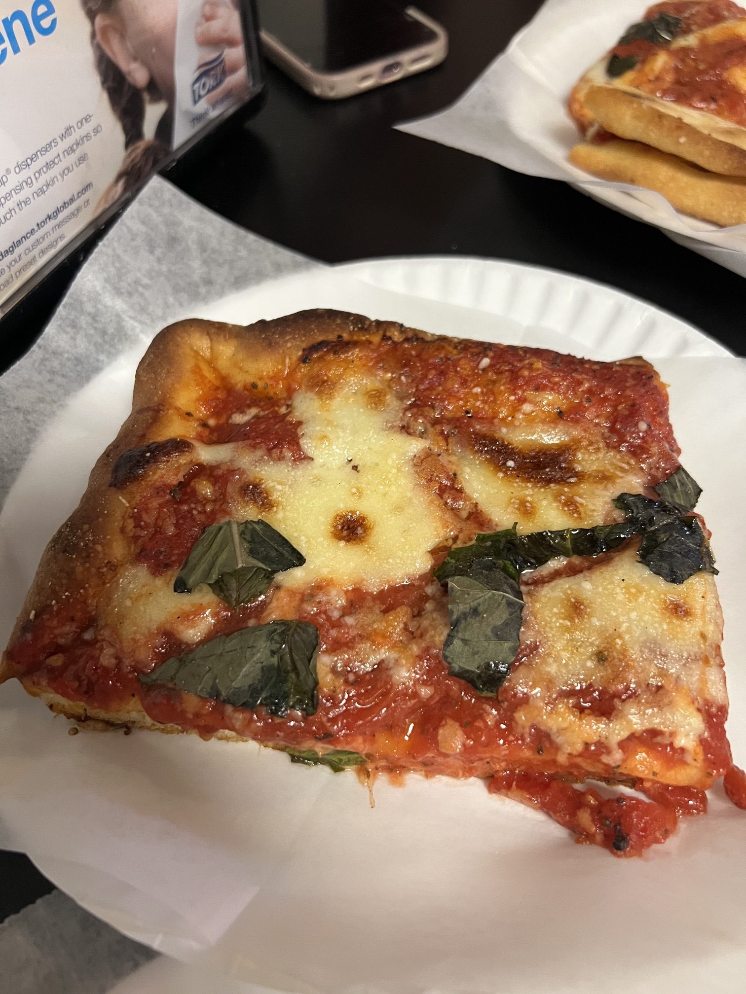 DiFara's renowned $8 Sicilian slice of pizza