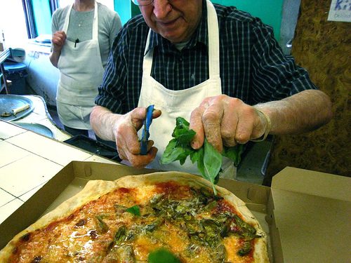 The practice of snipping fresh basil onto a pie right out of the oven started with DiFara